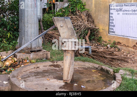 Belavadi, Karnataka, India - November 2, 2013: The government sponsored communal water pump of the village with white board agricultural planning sche Stock Photo