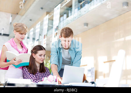 Students discussing over project at table in university Stock Photo