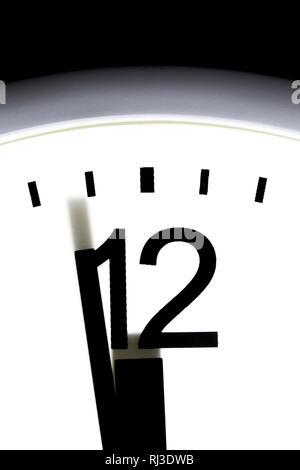 Close up of a clock showing one minute to 12, midnight. Stock Photo