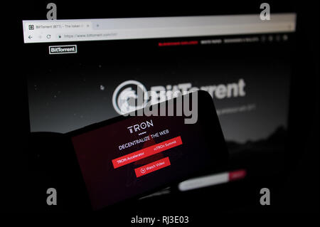 Tron and BiTorrent websites seen on a computer and phone screen Stock Photo