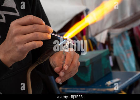Man making glass sculpture - hand blown glass artistry Stock Photo