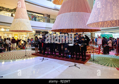 HONG KONG - DECEMBER 25, 2015: choir at ifc shopping mall in Hong Kong. Hong Kong shopping malls are some of the biggest and most impressive in the wo Stock Photo