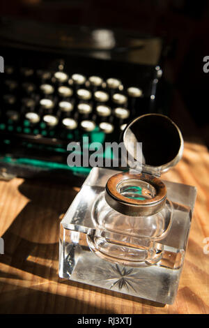 Antique crystal inkwell and a typewriter Stock Photo