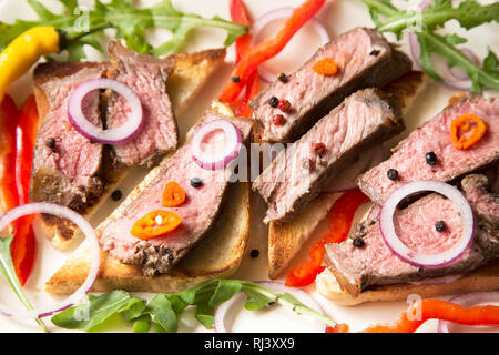 Sliced roast beef with vegetables close up Stock Photo