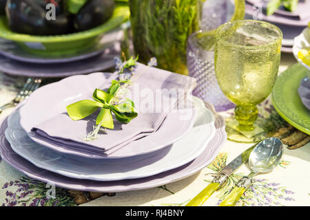 table serving and floral decoration green and violet colors with glass