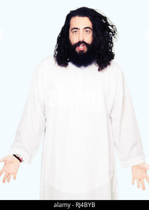 Man wearing Jesus Christ costume afraid and shocked with surprise expression, fear and excited face. Stock Photo