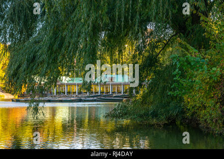 View of a boathouse beyond one of the ponds in New York City's Central Park. Stock Photo