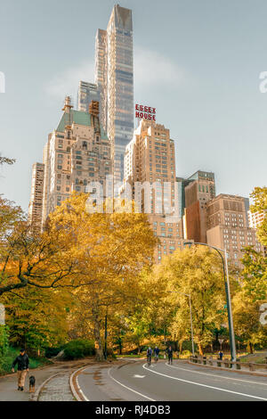 New York - October 31 2016: Colorful autumn day in Central Park New York with Essex House in the background. Stock Photo