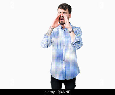 Young handsome business man over isolated background Shouting angry out loud with hands over mouth Stock Photo