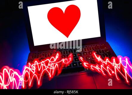 Symbol picture partnership agency, dating agency, red heart on screen of a notebook, Germany Stock Photo