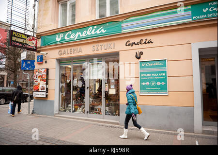 Girl walking in front of Polish Cepelia art gallery shop with handmade craft boutique in Warsaw, Poland, Chmielna St, Stock Photo