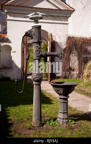 Old deep well pump device in private backyard in Poland, decorative ...