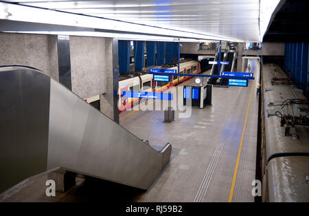 Railway train carriages in underground station, empty platforms and escalators, vehicles waiting for passengers in central Warsaw, Poland, Stock Photo