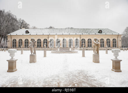 Statue in front of Old Orangery in Royal Baths Park in Warsaw, Snow and winter weather in park, Polish Lazienki Krolewskie, Poland, Europe, Stock Photo