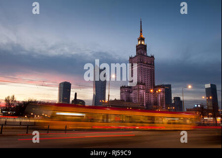 Tram motion and Palace of Culture and Science, Palac Kultury i Nauki, PKiN, in central Warsaw, Poland, Dec, 2013, Twilight and street lamps in the cit Stock Photo