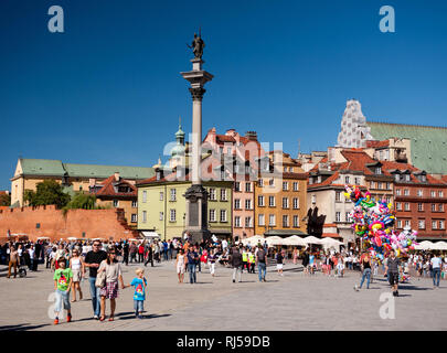 Zygmunt Monument and tourists walking at Royal Castle square in Old Town in Warsaw, Poland, Summertime tourism season, Stock Photo