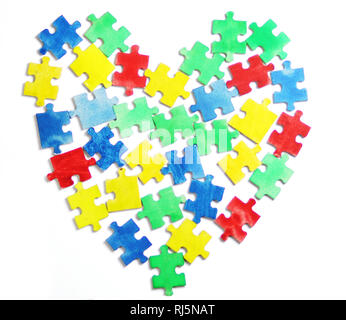 Colourful jigsaw puzzle and alphabet tiles with AUTISM word. Autism concept Stock Photo