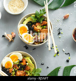 Top view poke bowls of fried rice, chicken fillet and eggs top view. Asian food concept Stock Photo