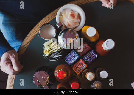 cluttered cafe table with condiments Stock Photo