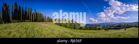 Typical hilly Tuscan countryside with fields and cypresses, Castello di Romena located on top of a hill Stock Photo