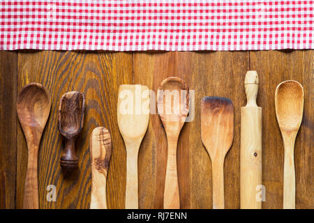 Wooden kitchen utensils on vintage wooden table