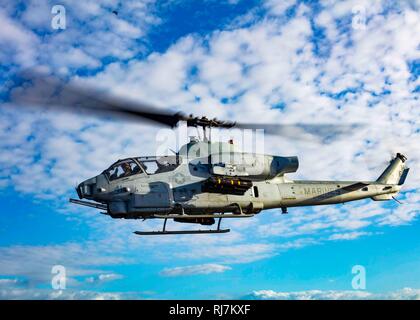 190130-N-HG389-0055 MEDITERRANEAN SEA (Jan. 30, 2019) An AH-1W Super Cobra helicopter assigned to the “Black Knights” of Marine Medium Tiltrotor Squadron (VMM) 264 (Reinforced) departs the flight deck of San Antonio-class amphibious transport dock ship USS Arlington (LPD 24), Jan. 30, 2019. Arlington is on a scheduled deployment as part of the Kearsarge Amphibious Ready Group in support of maritime security operations, crisis response and theater security cooperation, while also providing a forward naval presence. (U.S. Navy photo by Mass Communication Specialist 2nd Class Brandon Parker/Relea Stock Photo