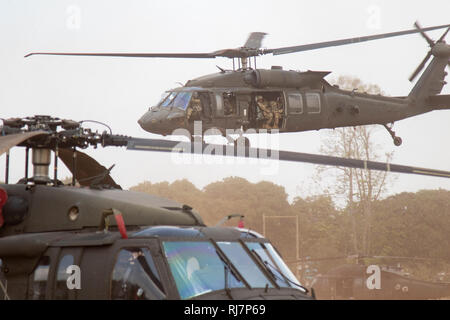 A Sikorsky UH-60 Black Hawk with 2nd Battalion, 25th Aviation Regiment, transports Soldiers with B Company, 5th Battalion, 20th Infantry Regiment, to a training area Jan. 31, 2019, at Camp Nimman Kolayut, Thailand. This was during Hanuman Guardian, a training exercise designed to increase readiness, interoperability and collaboration among partner nations in order to achieve effective solutions to common challenges. (U.S. Army photo by Spc. Maurice Washington) Stock Photo