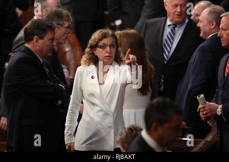 Washington DC, USA. 5th February, 2019. United States Representative Debbie Wasserman-Schultz (Democrat of Florida) points towards the gallery from the floor prior to US President Donald J. Trump delivering his second annual State of the Union Address to a joint session of the US Congress in the US Capitol in Washington, DC on Tuesday, February 5, 2019. She is wearing white in response to Representative Lois Frankel's call to acknowledge the voters who handed Democrats a majority in the House in the midterm elections and a reminder that they plan to make women's economic security a priority. C Stock Photo