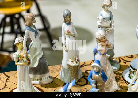 CESENA, ITALY - NOVEMBER 18, 2018: lights are enlightening ceramic dolls for sale in Antiques Fair Stock Photo