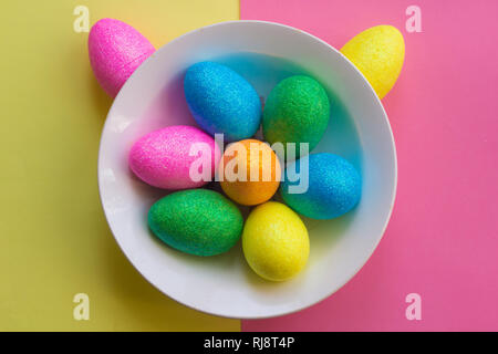 Easter card. Painted eggs in a basket and flowers in a vase. Orthodox holiday. Religion and culture Stock Photo
