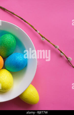 Easter card. Painted eggs in a basket and flowers in a vase. Orthodox holiday. Religion and culture Stock Photo