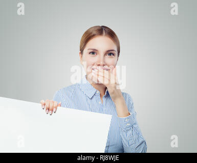 Surprised business woman laughing and holding white empty board background with copy space for advertising marketing or product placement. Businesswom Stock Photo