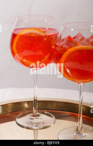 Spritz veneziano, an IBA cocktail, with Prosecco or white sparkling wine, bitter, soda, ice and a slice of orange, in a calix on a table, pop graphic Stock Photo