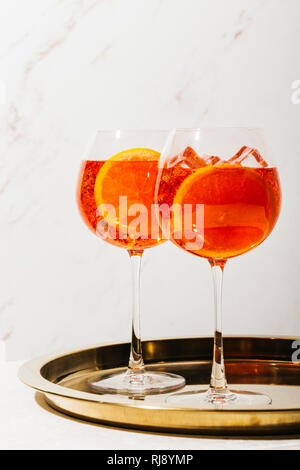 Spritz veneziano, an IBA cocktail, with Prosecco or white sparkling wine, bitter, soda, ice and a slice of orange, in a calix on a table, pop graphic Stock Photo