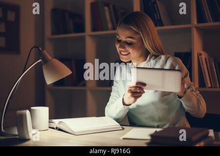 Student learning at home. Using digital tablet. Stock Photo