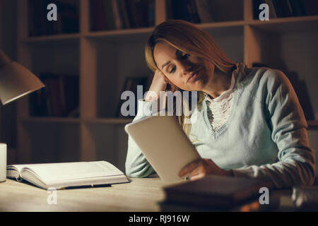 Student learning at home. Using digital tablet. Stock Photo
