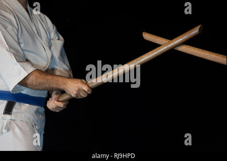 Aikido fighter with his wood stick during a combat Stock Photo