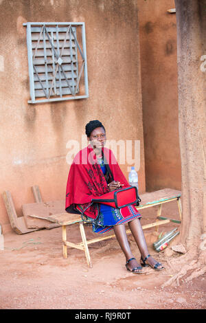 SEMUS compound Yako, Burkina Faso, 29th November 2016; Young woman working as a translator. Stock Photo