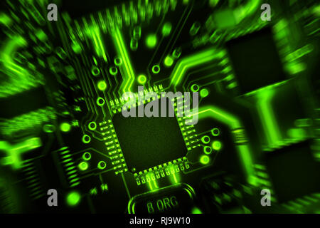 Circuit board with components in green tones. Abstract high tech background. Zoom effect. Stock Photo