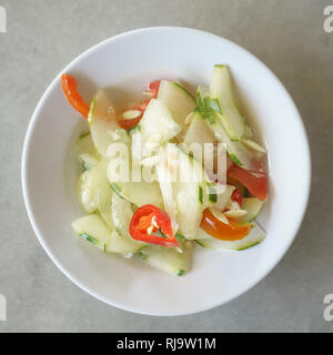 Malaysian street food acar timun or cucumber pickle on table setup. Stock Photo