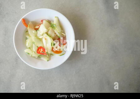 Malaysian street food acar timun or cucumber pickle on table setup. Stock Photo