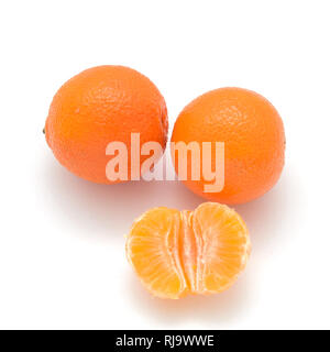 two Mandarin and one half isolated on white background Stock Photo