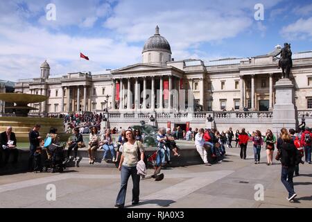 LONDON, UK - MAY 13, 2012: People visit Trafalgar Square in London. With more than 14 million international arrivals in 2009, London is the most visit Stock Photo