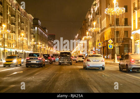 MOSCOW, RUSSIA - JANUARY 26, 2019: cars drive on Tverskaya street in Moscow city at winter night. Tverskaya Street (former Gorky Street) is the main r Stock Photo
