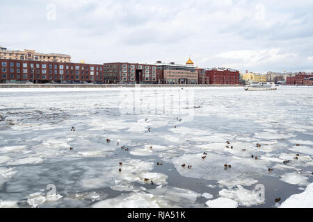 ducks on ice floes in Moskva River and view of Prechistenskaya embankment and Cathedral of Christ the Saviour in Moscow city in winter Stock Photo