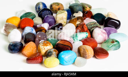 handful of various gem stones on white board Stock Photo