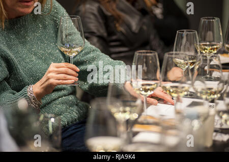 People tasting white wine during a masterclass. Stock Photo