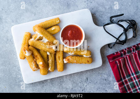 Breaded Fried Mozzarella Cheese Sticks with Ketchup Dipping Sauce. Homemade Fast Food. Stock Photo