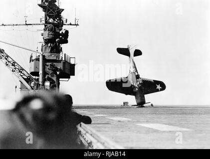 US Air Force Douglas SBD Dauntless, dive bomber, on its' nose, after crash landing, on an American aircraft carrier flight deck. World War Two; 1943 Stock Photo