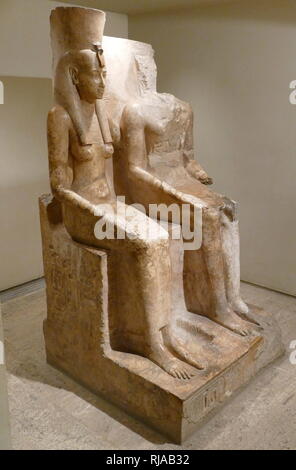 Statue of the Goddess Mut and the God Amun. XIX Dynasty, Reign of Ramesses II. Circa 1290-1224 BC; Mut was the mother goddess of Thebes. Amun was one of the eight ancient Egyptian gods who formed the Ogdoad of Hermopolis. He was the god of the air. During the Twelfth dynasty (Middle Kingdom) Amun was adopted in Thebes, as the King of the gods with Mut as his consort Stock Photo